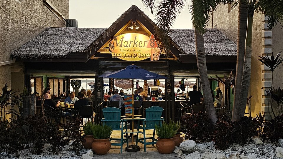 Tiki bar seating beside the water.